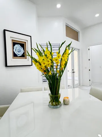 a large white kitchen with a large window