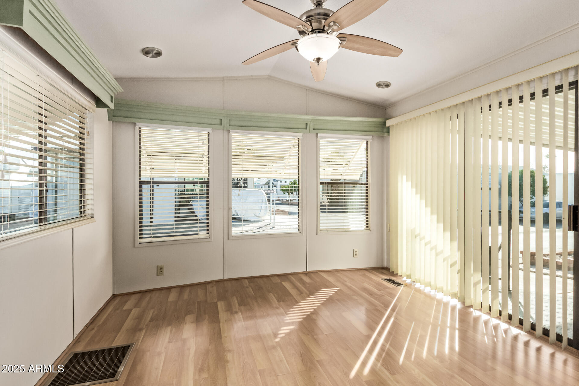 111 South Greenfield Road, Unit 647 Mesa, AZ 85206 - Photo 12 of 29 a view of an empty room and window a ceiling fan