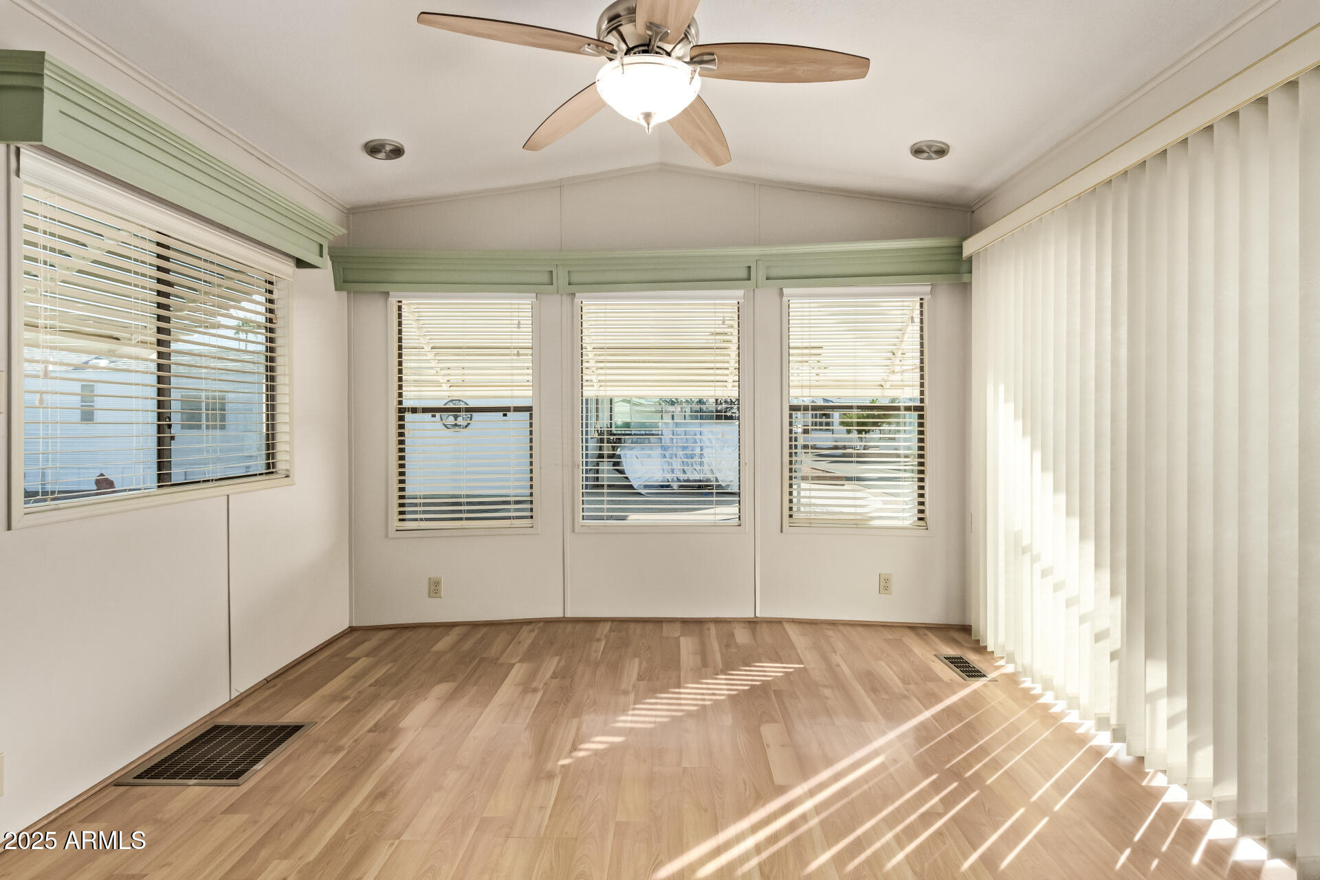 111 South Greenfield Road, Unit 647 Mesa, AZ 85206 - Photo 13 of 29 a view of an empty room with a window and a ceiling fan