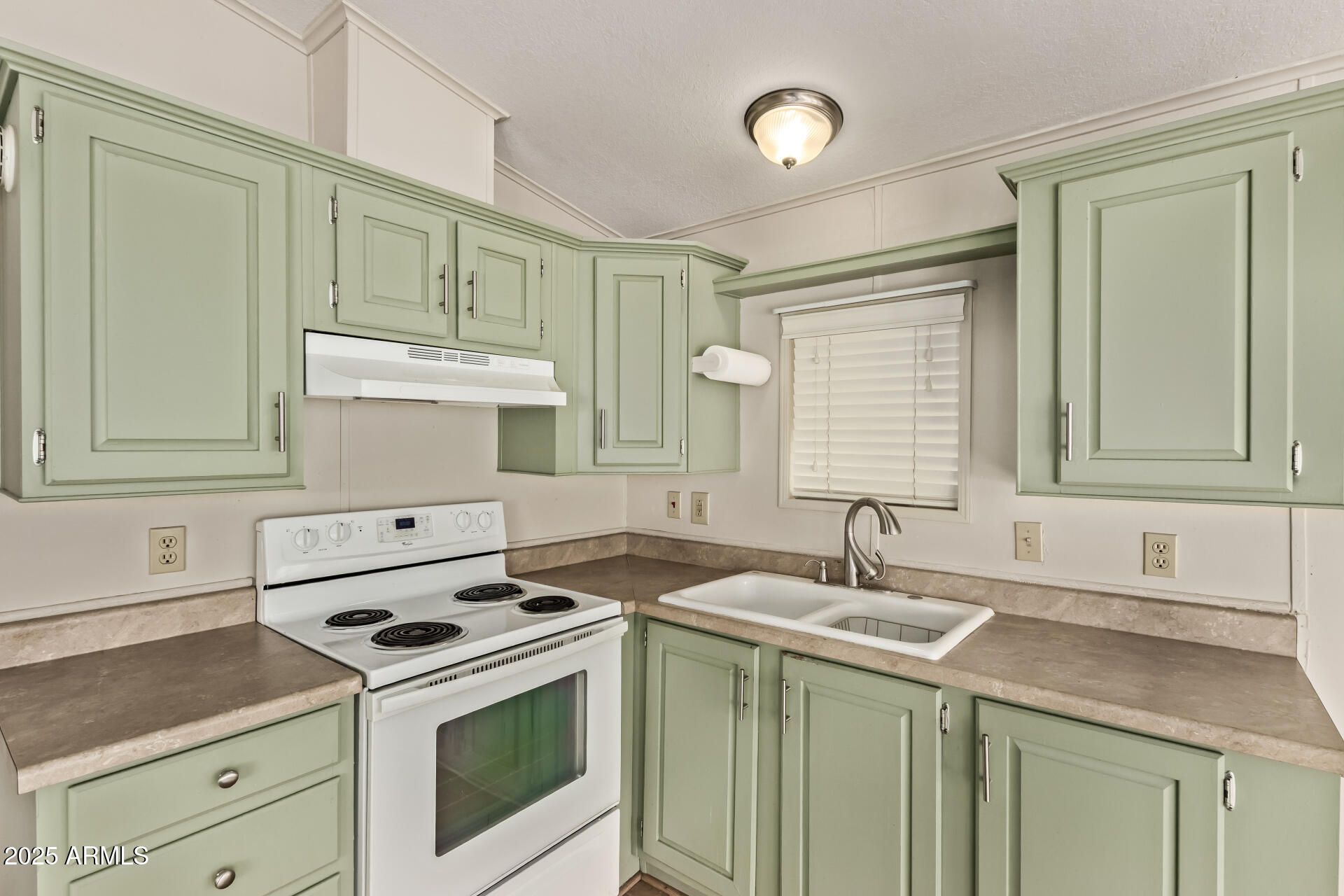 111 South Greenfield Road, Unit 647 Mesa, AZ 85206 - Photo 9 of 29 a kitchen with a sink stove top oven and cabinets