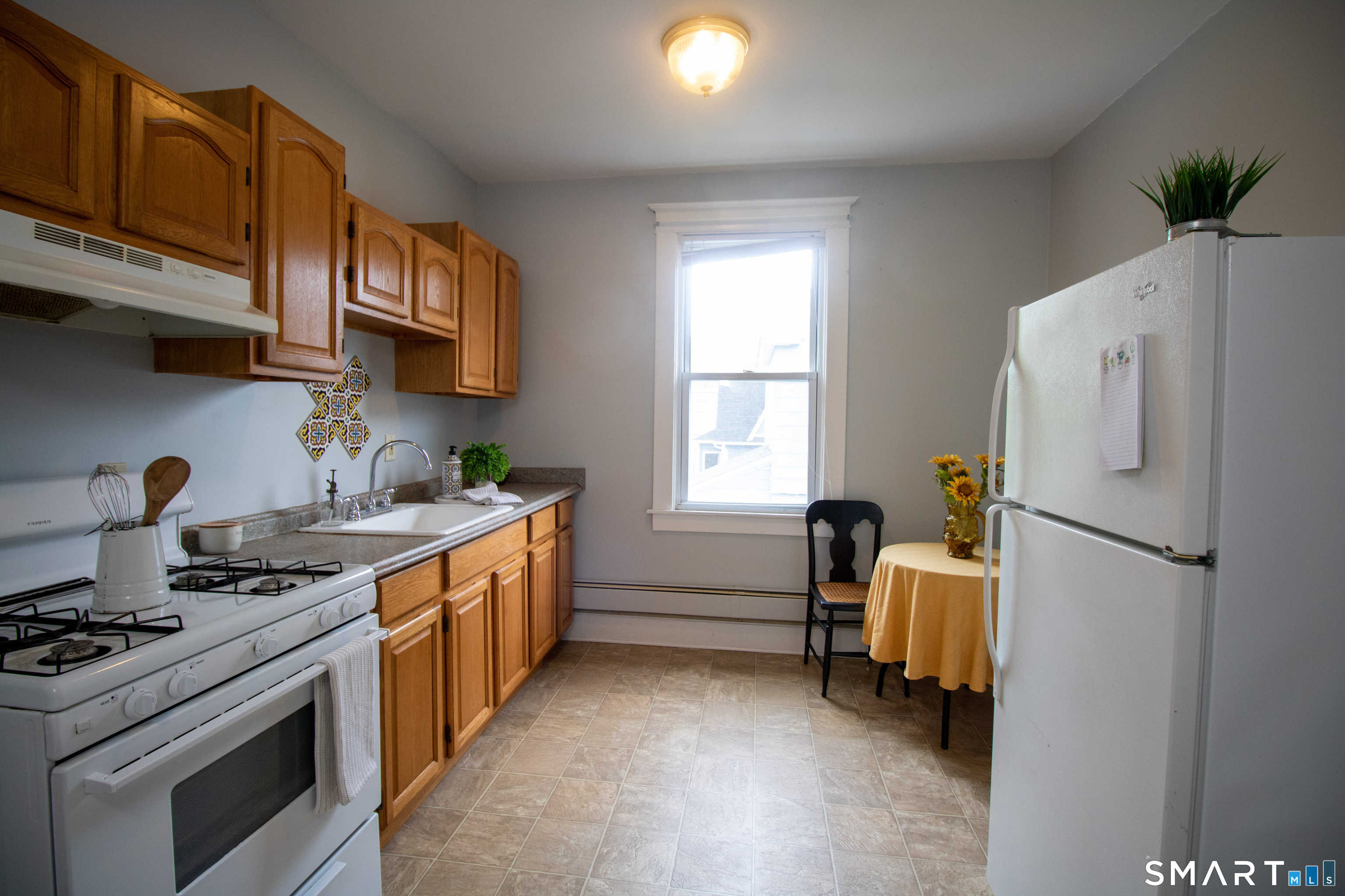 a kitchen with a stove a refrigerator and a sink