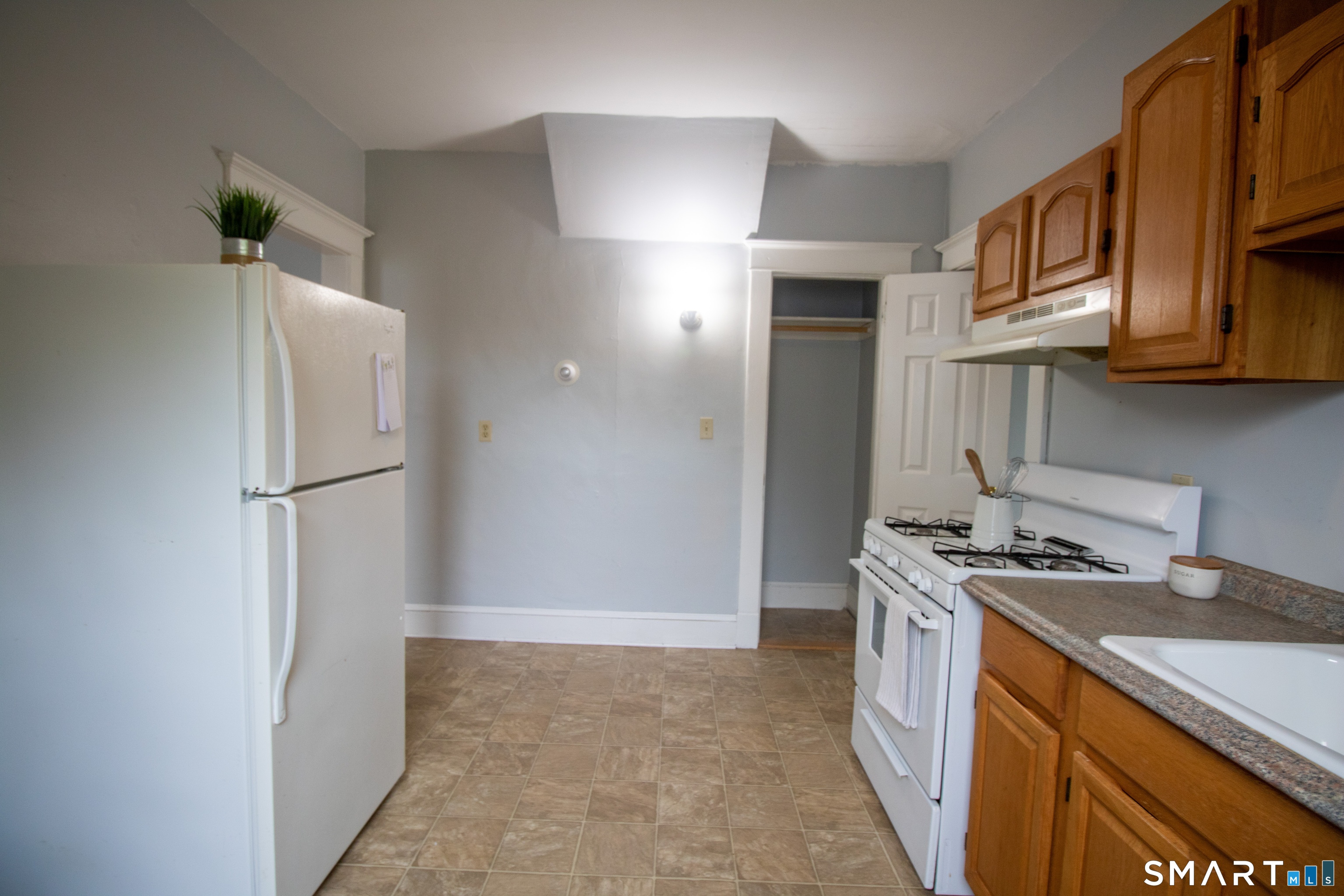 88 Riverview Avenue New London, CT 06320 - Photo 2 of 6 a kitchen with stainless steel appliances granite countertop a refrigerator a stove and a sink