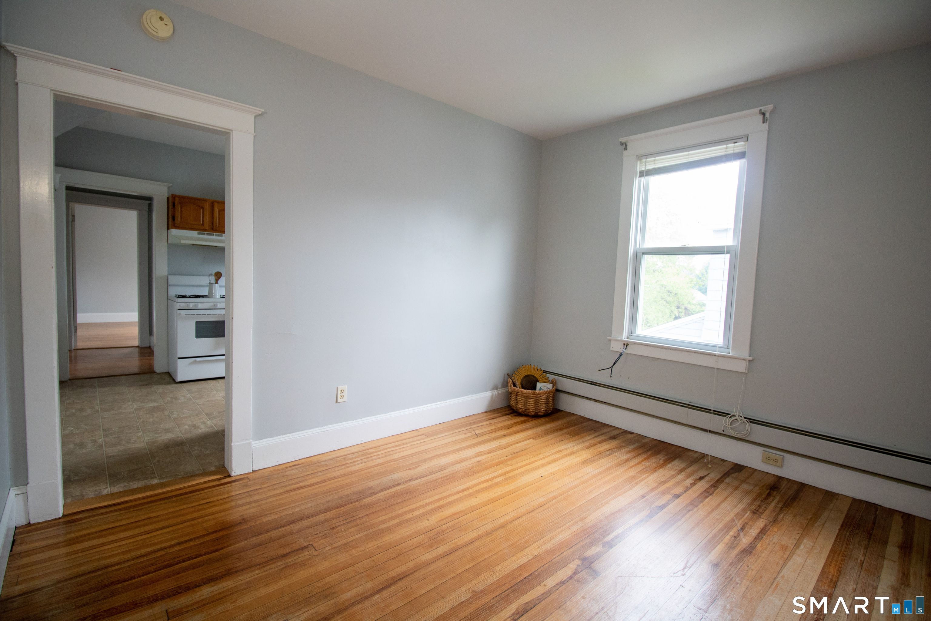 88 Riverview Avenue New London, CT 06320 - Photo 3 of 6 an empty room with wooden floor and windows