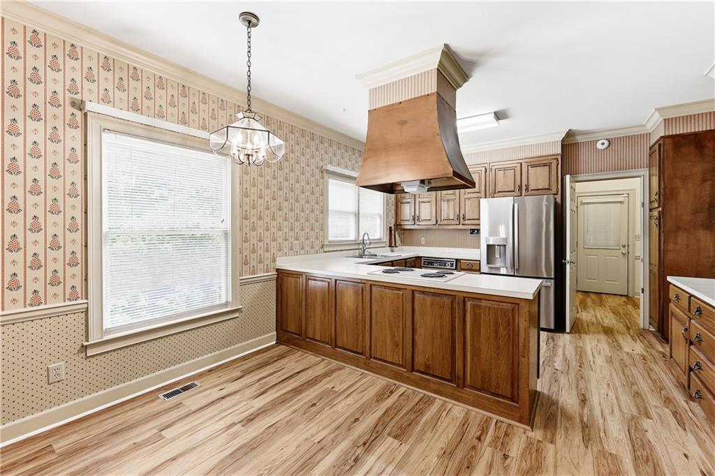 3608 Maple Forge Lane Gainesville, GA 30504 - Photo 12 of 45 a kitchen with stainless steel appliances granite countertop a stove a refrigerator and a wooden floor