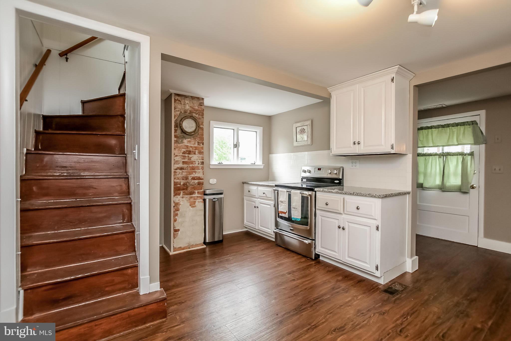2429 Stanwick Road Phoenix, MD 21131 - Photo 11 of 30 a kitchen with granite countertop white cabinets and white appliances