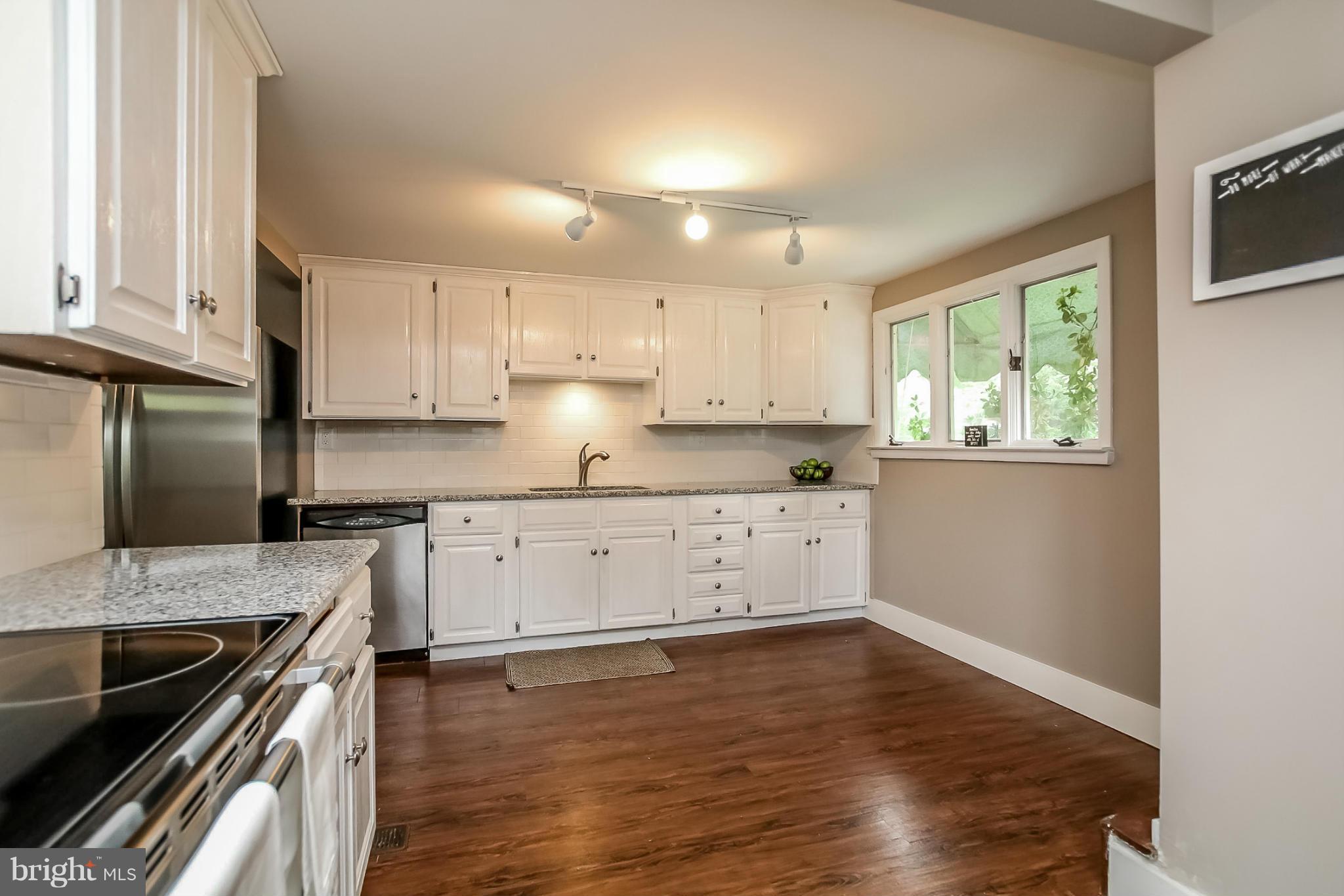 2429 Stanwick Road Phoenix, MD 21131 - Photo 12 of 30 a kitchen with granite countertop stainless steel appliances a stove sink and cabinets