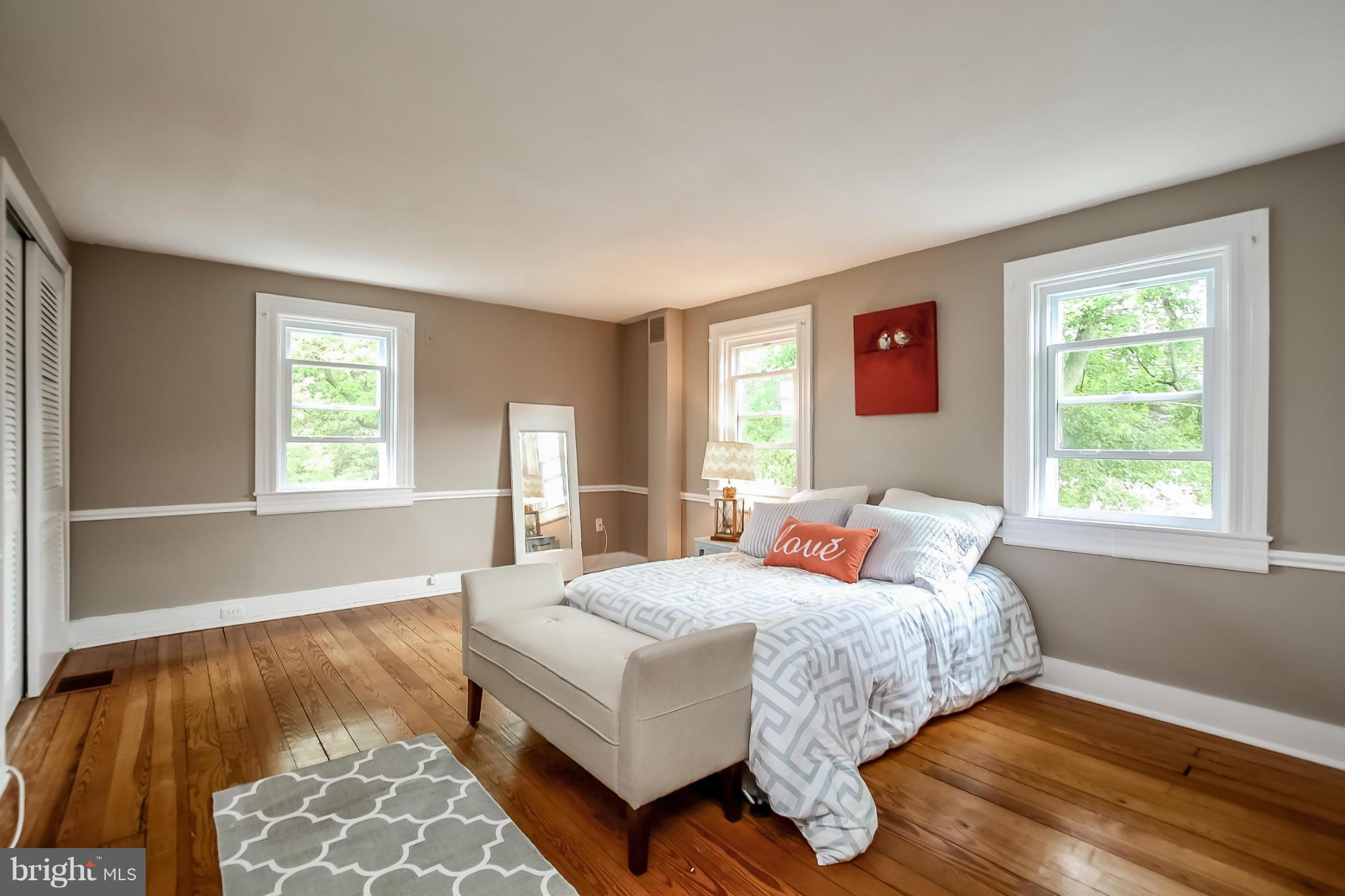 2429 Stanwick Road Phoenix, MD 21131 - Photo 14 of 30 a bedroom with a bed and wooden floor