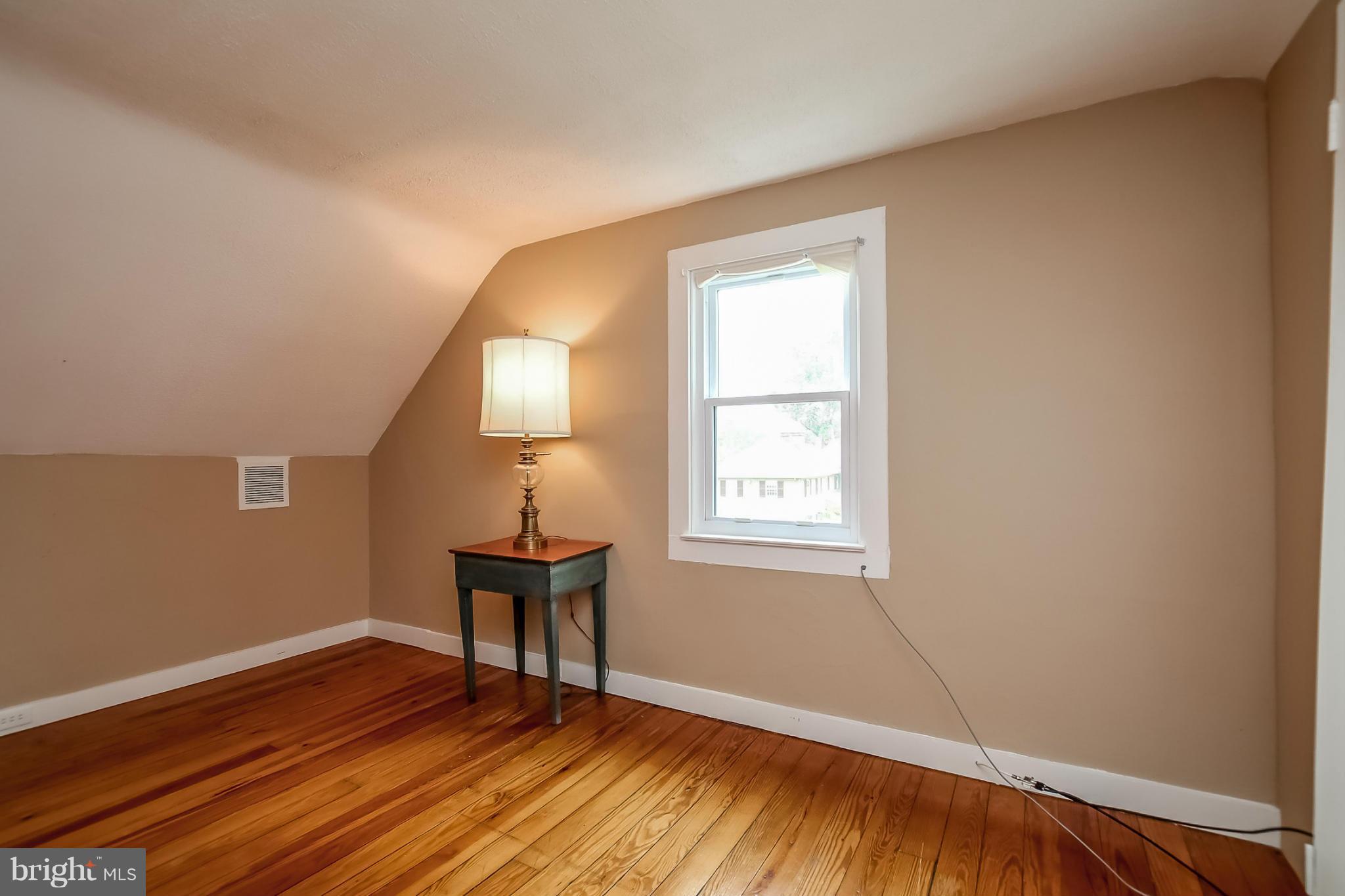 2429 Stanwick Road Phoenix, MD 21131 - Photo 23 of 30 a view of an empty room with window and wooden floor