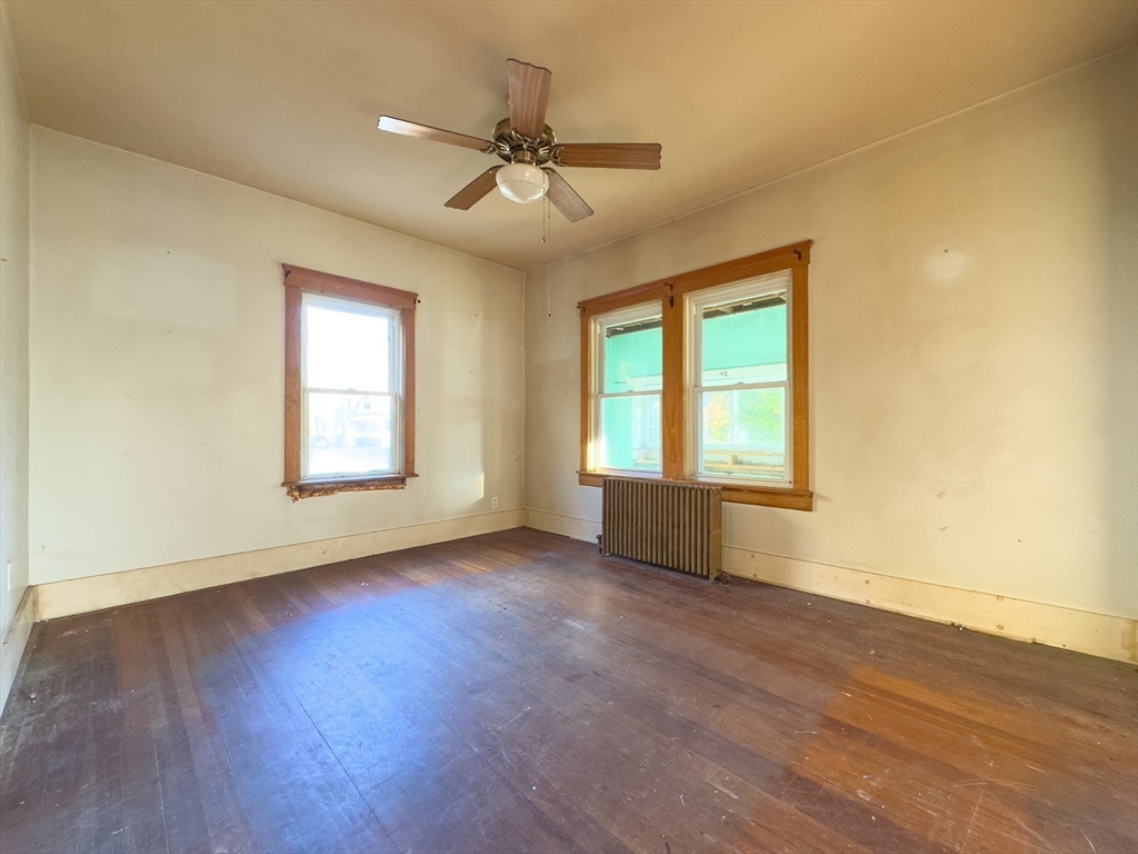 16 Ash Street Fairhaven, MA 02719 - Photo 14 of 25 a view of an empty room with wooden floor and a window