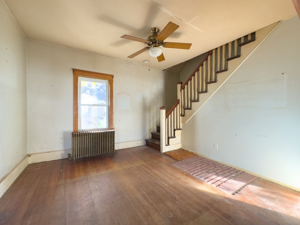 16 Ash Street Fairhaven, MA 02719 - Photo 15 of 25 a view of an empty room with wooden floor and a window