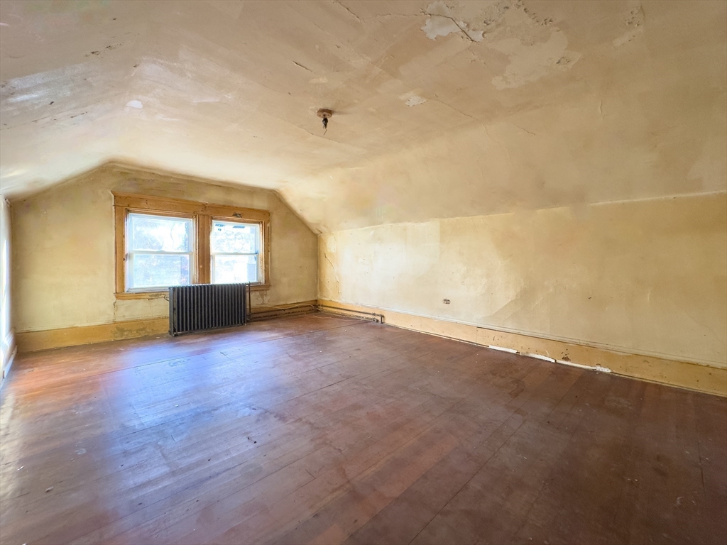 16 Ash Street Fairhaven, MA 02719 - Photo 19 of 25 an empty room with wooden floor and windows