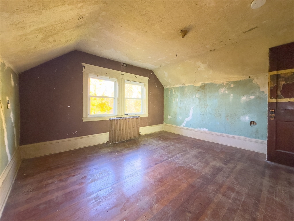 16 Ash Street Fairhaven, MA 02719 - Photo 22 of 25 a view of an empty room with a window and wooden floor