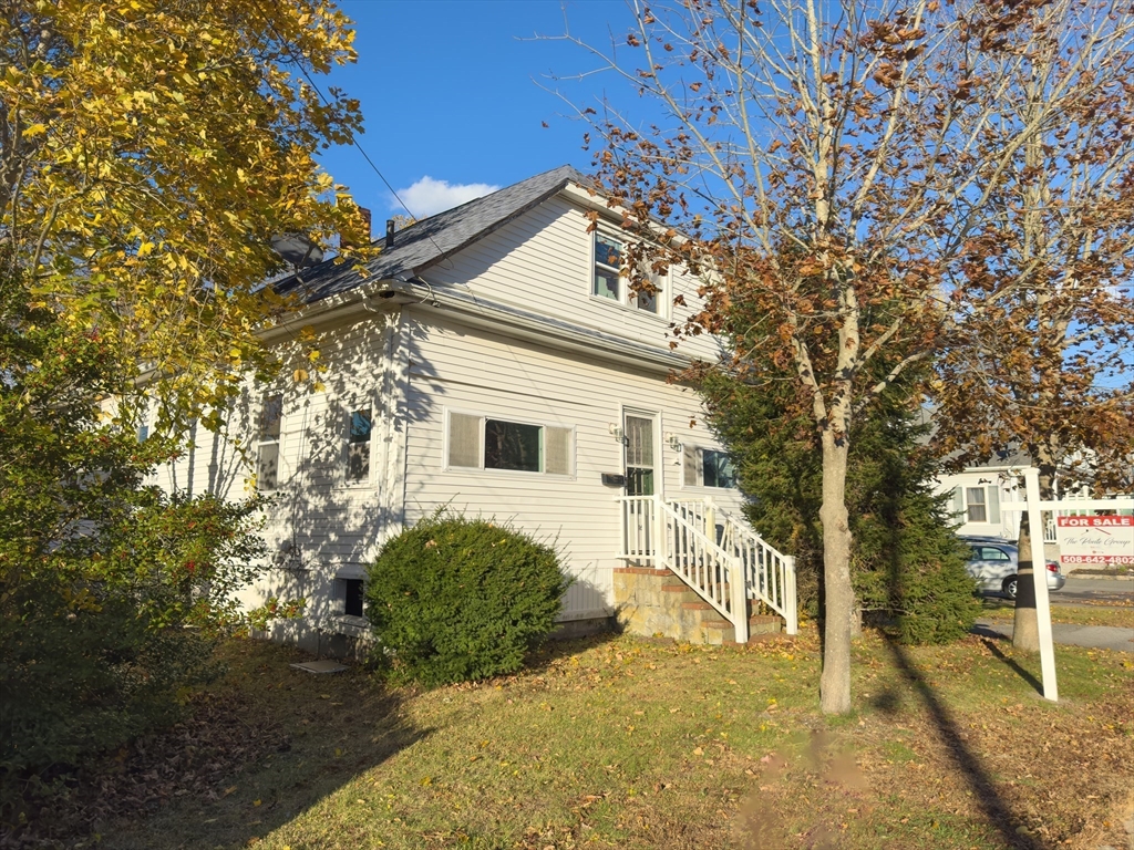 16 Ash Street Fairhaven, MA 02719 - Photo 23 of 25 a view of a house with a large tree and a yard