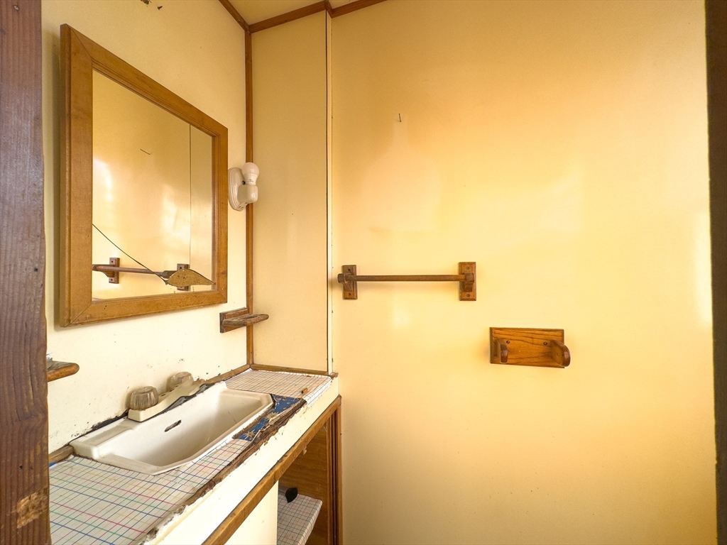 16 Ash Street Fairhaven, MA 02719 - Photo 10 of 25 a bathroom with a sink and a mirror