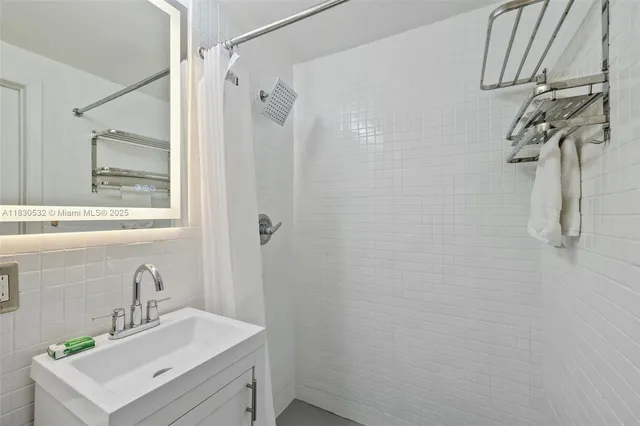 a bathroom with a sink a mirror and shower