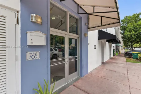 a view of a hallway with a refrigerator and a stove