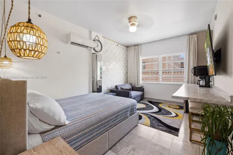 a bedroom that has a bed and a chandelier