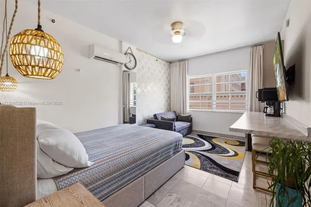 a bedroom that has a bed and a chandelier