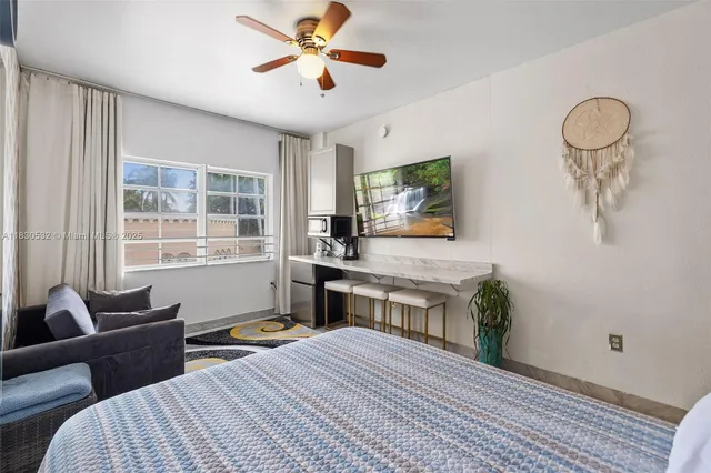 a bedroom with furniture and a window