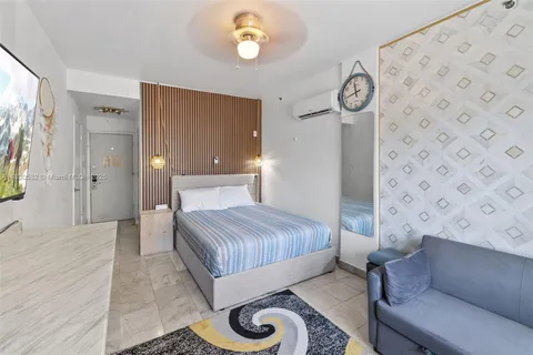 a bedroom with a bed couch and a window