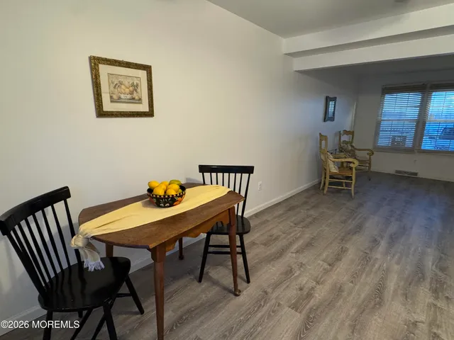 a view of a workspace with furniture wooden floor and a window