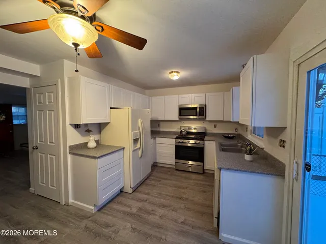 a kitchen with stainless steel appliances granite countertop a stove and a refrigerator