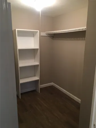 a view of a room with wooden floor