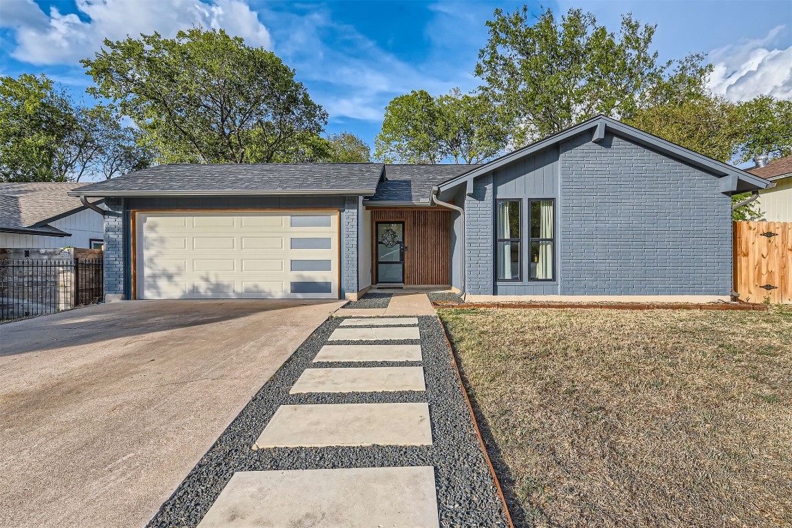 1112 Milford Way Austin, TX 78745 - Photo 1 of 25 a front view of a house with a yard and garage