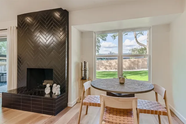 a living room with a table and a fireplace