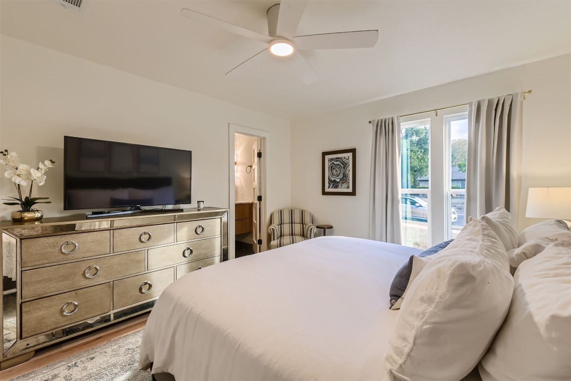 1112 Milford Way Austin, TX 78745 - Photo 12 of 25 a bedroom with a large bed and flat tv