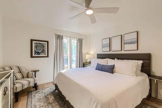 a bedroom with a bed and ceiling fan