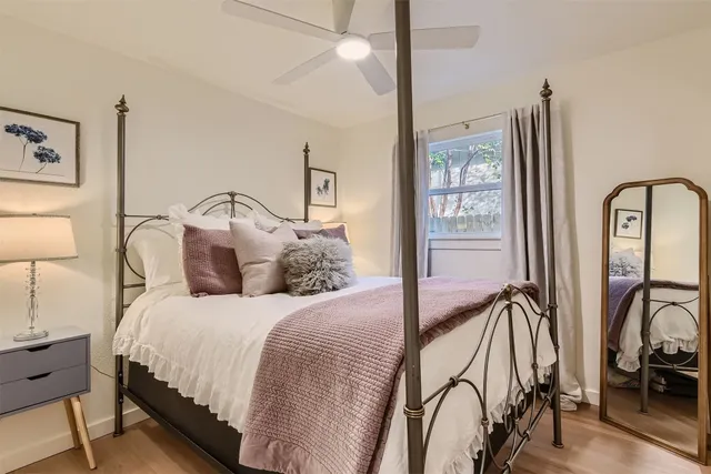 a bedroom with a large bed and flat screen tv