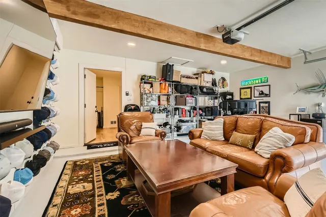 a living room with furniture a rug and a flat screen tv