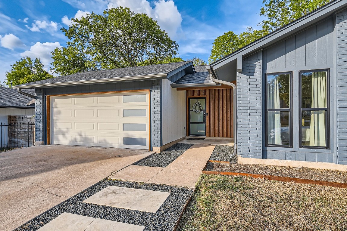 1112 Milford Way Austin, TX 78745 - Photo 3 of 25 a front view of a house with a yard and garage