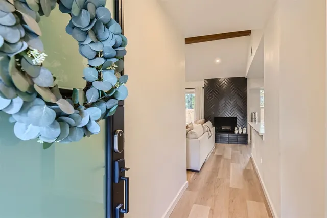 a view of entryway and hall with wooden floor