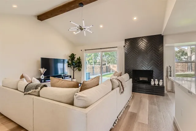 a living room with furniture a fireplace and a flat screen tv