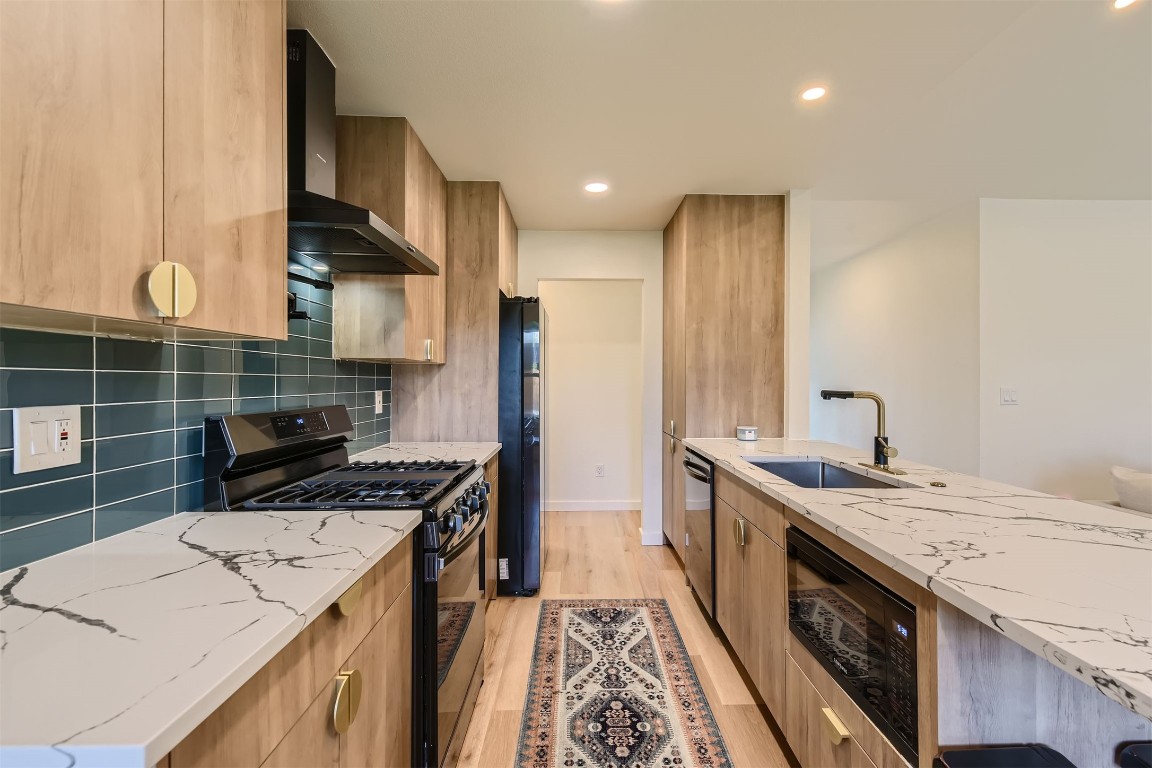 1112 Milford Way Austin, TX 78745 - Photo 9 of 25 a kitchen with a stove and a sink