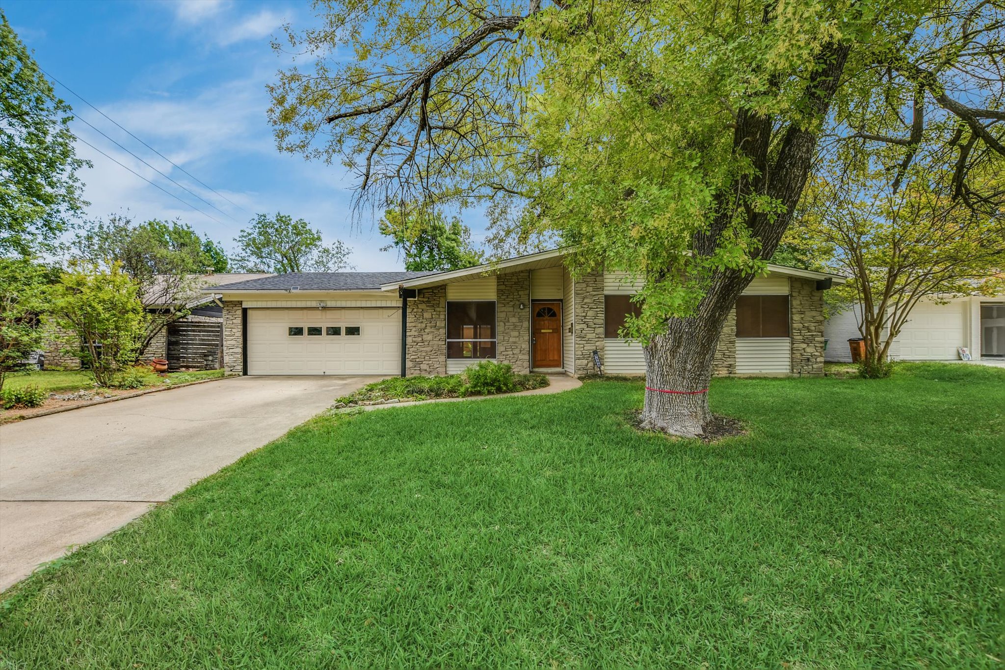 a front view of house with yard and green space