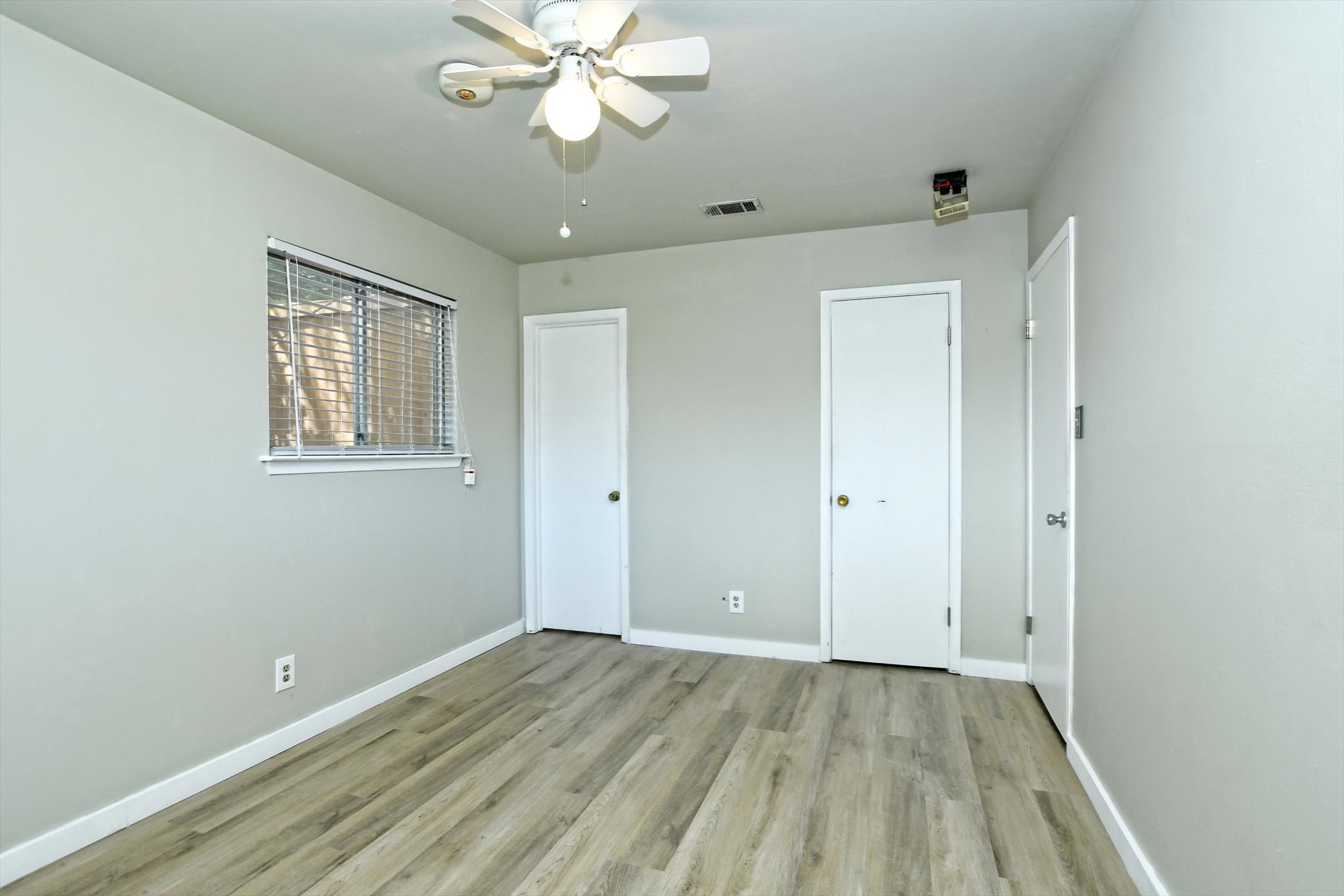 7509 Daugherty Street Austin, TX 78757 - Photo 11 of 24 wooden floor in an empty room with a window