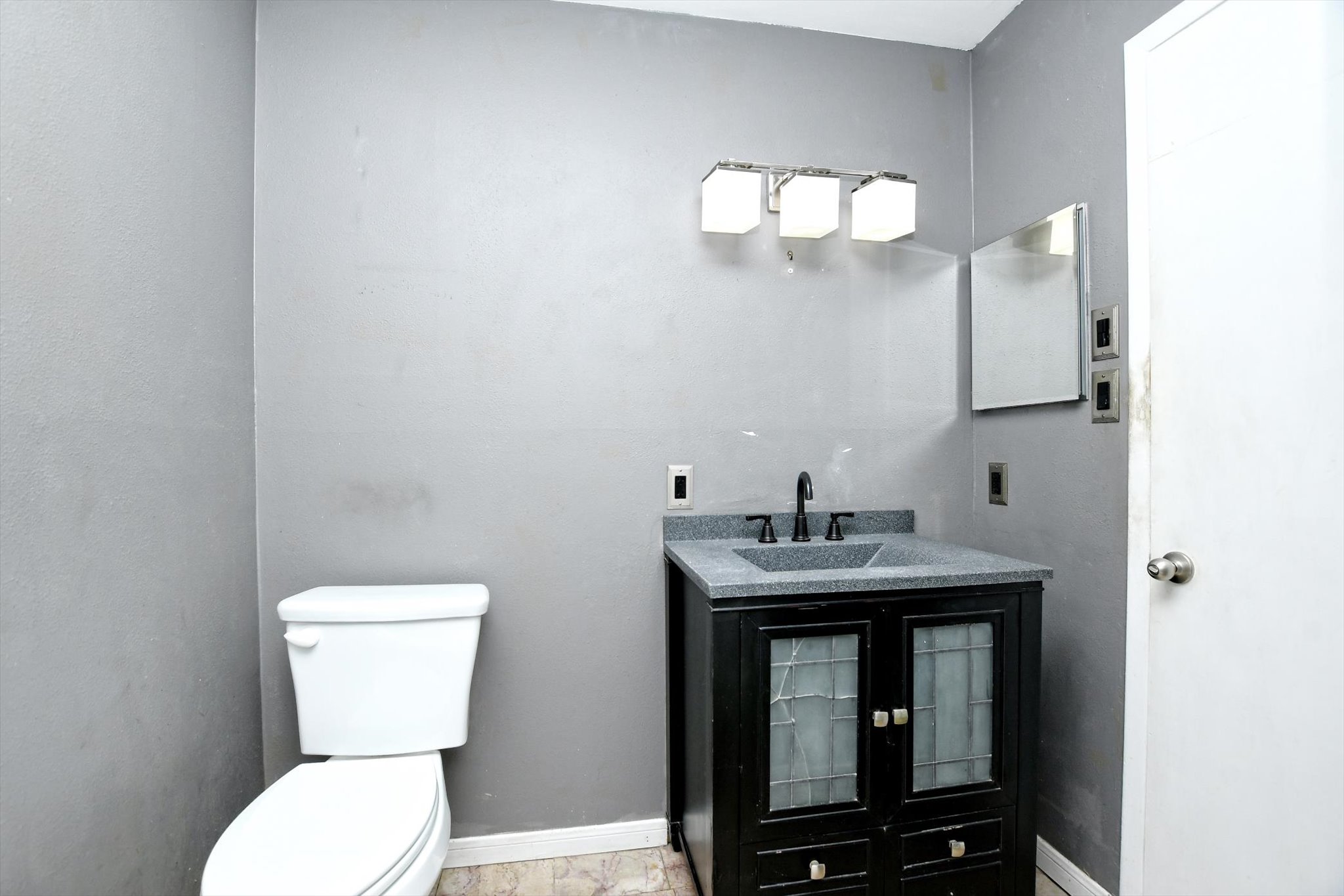 7509 Daugherty Street Austin, TX 78757 - Photo 15 of 24 a bathroom with a toilet a sink and mirror