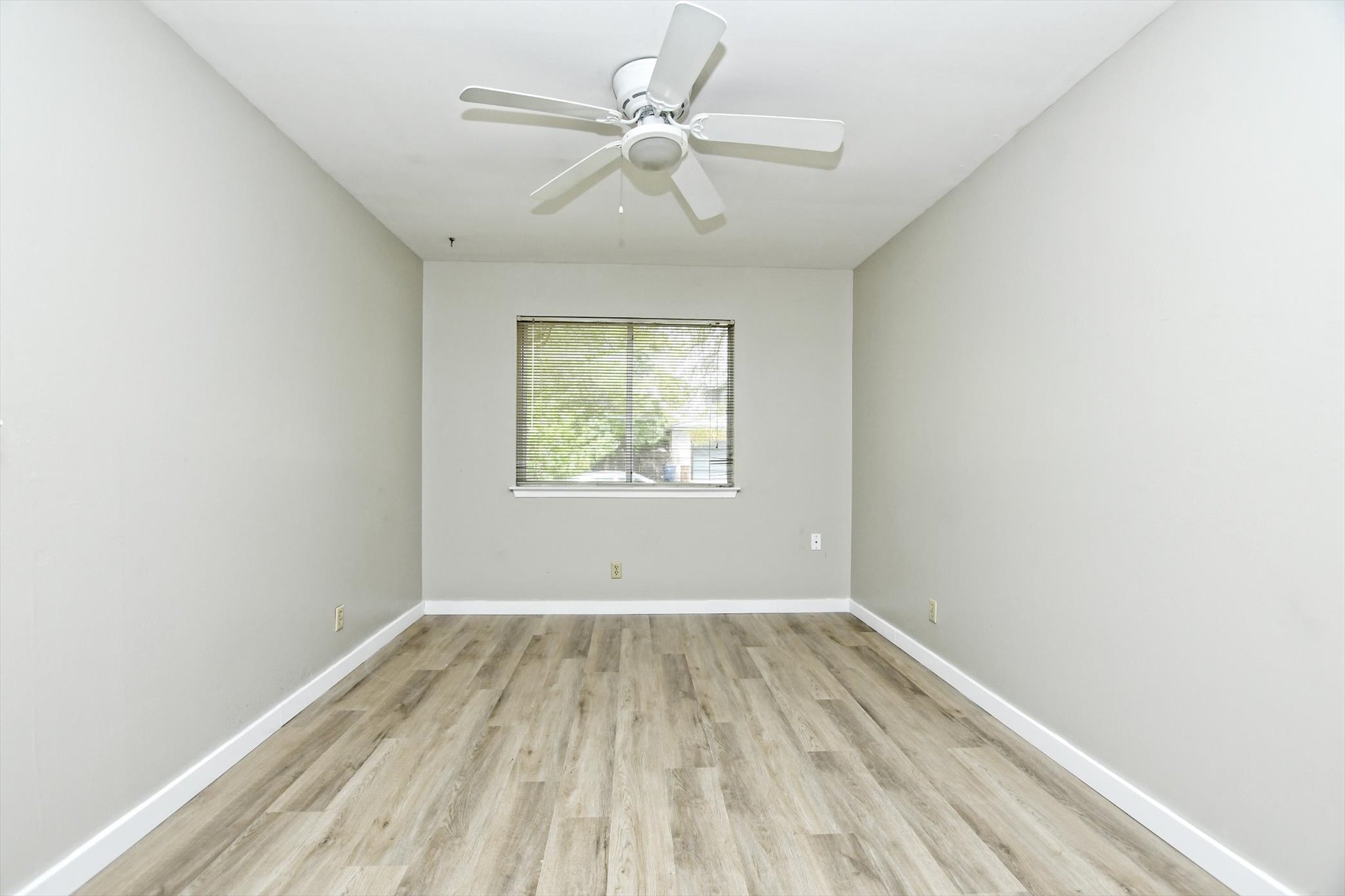 7509 Daugherty Street Austin, TX 78757 - Photo 17 of 24 an empty room with a window and a ceiling fan