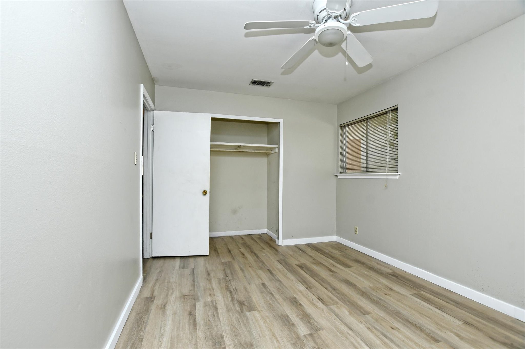 7509 Daugherty Street Austin, TX 78757 - Photo 18 of 24 wooden floor in an empty room with a window