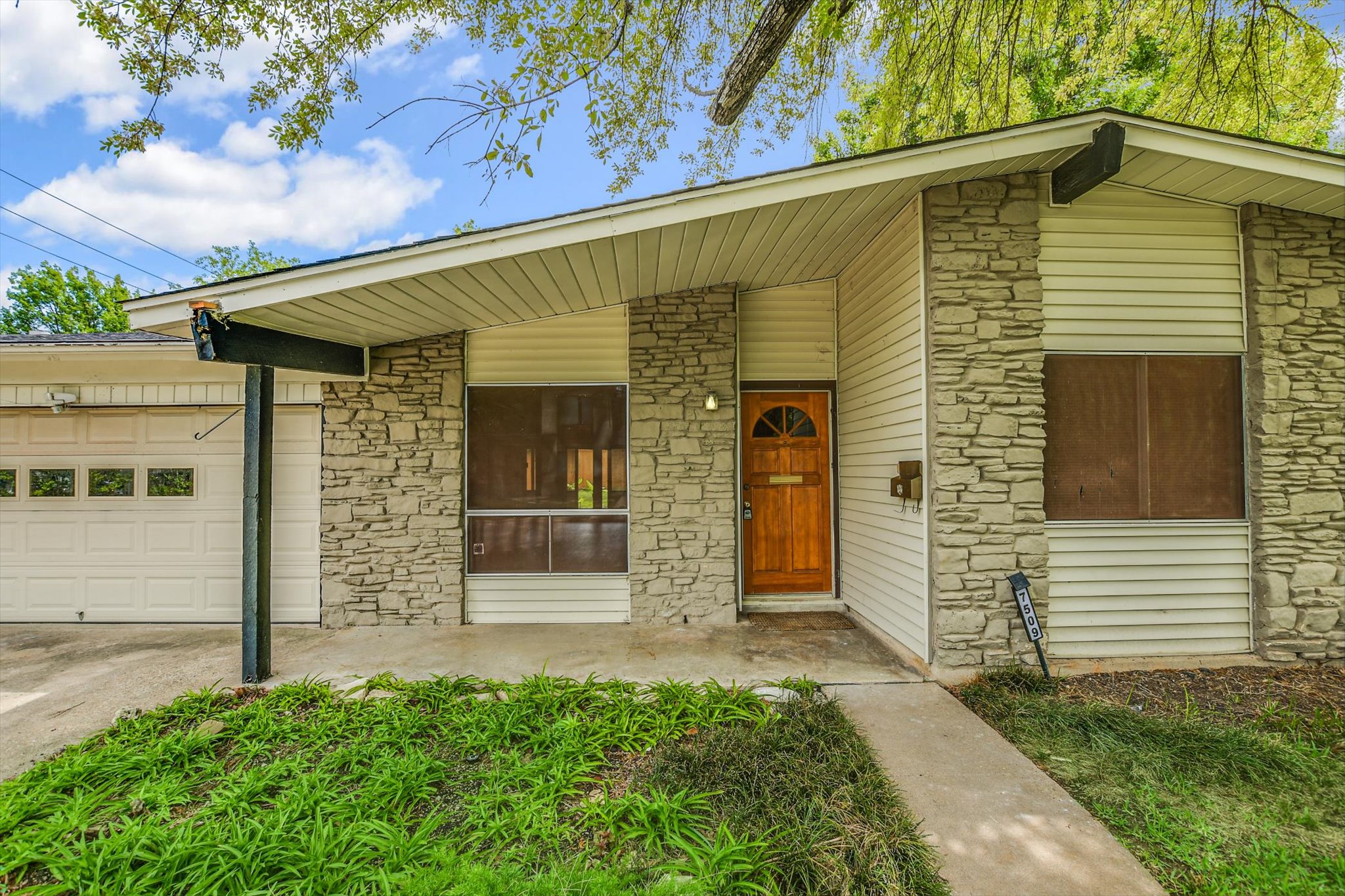 7509 Daugherty Street Austin, TX 78757 - Photo 2 of 24 a front view of a house with a garage