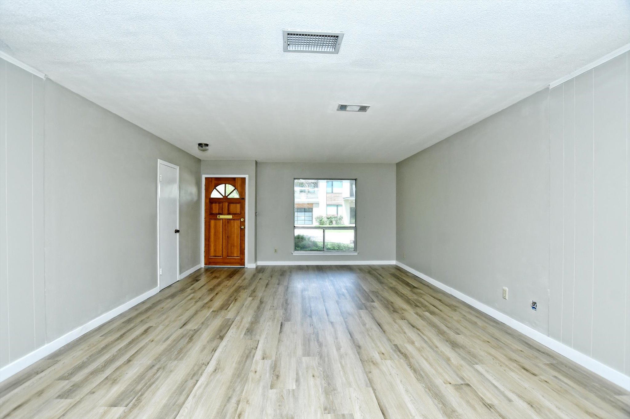 7509 Daugherty Street Austin, TX 78757 - Photo 3 of 24 wooden floor in an empty room with a window