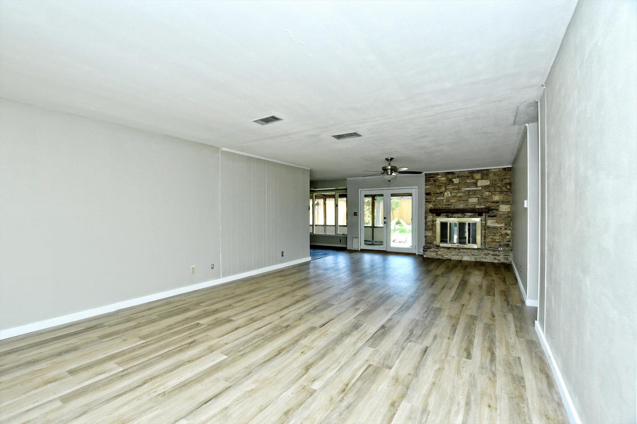 7509 Daugherty Street Austin, TX 78757 - Photo 5 of 24 wooden floor in an empty room with a window