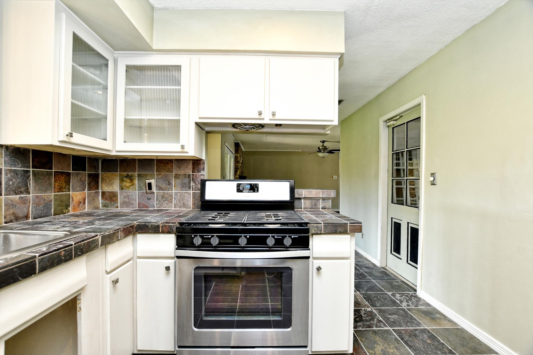 7509 Daugherty Street Austin, TX 78757 - Photo 7 of 24 a kitchen with a stove and a microwave
