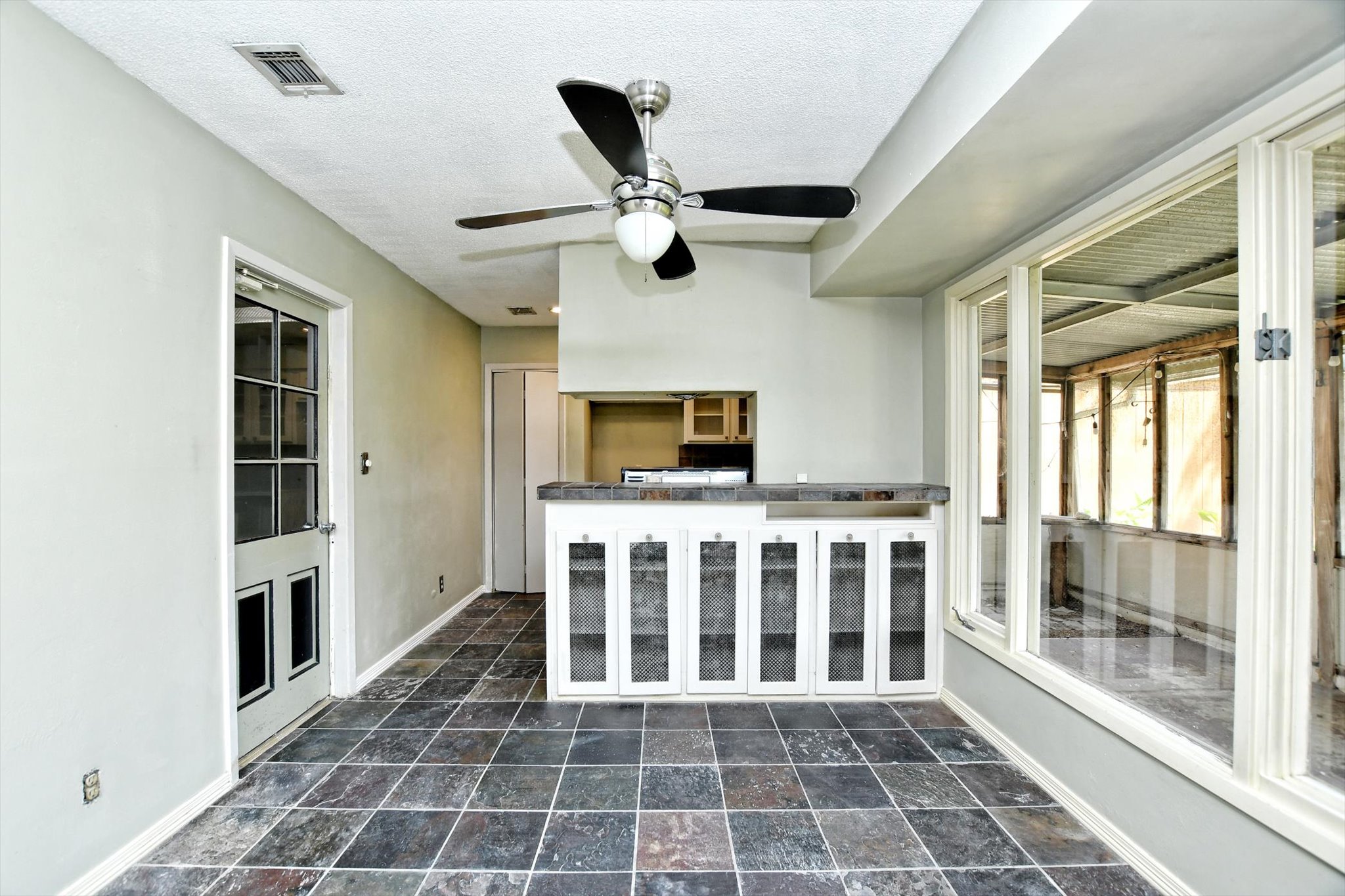 7509 Daugherty Street Austin, TX 78757 - Photo 8 of 24 a view of an empty room with wooden floor and windows
