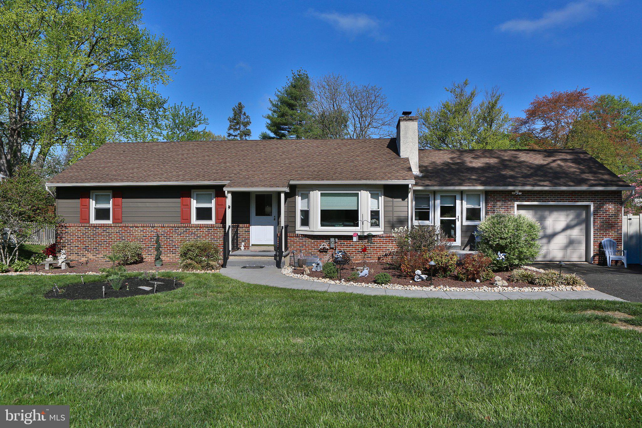 a front view of a house with a garden and patio