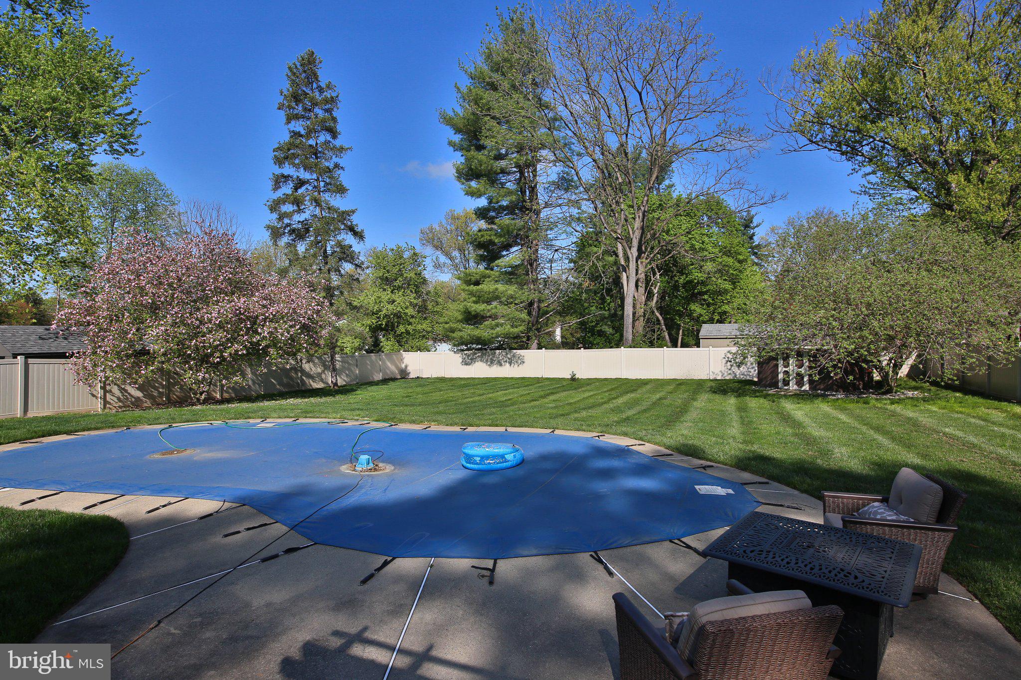158 South Shady Retreat Road Doylestown, PA 18901 - Photo 4 of 22 a view of a backyard with table and chairs under a large tree