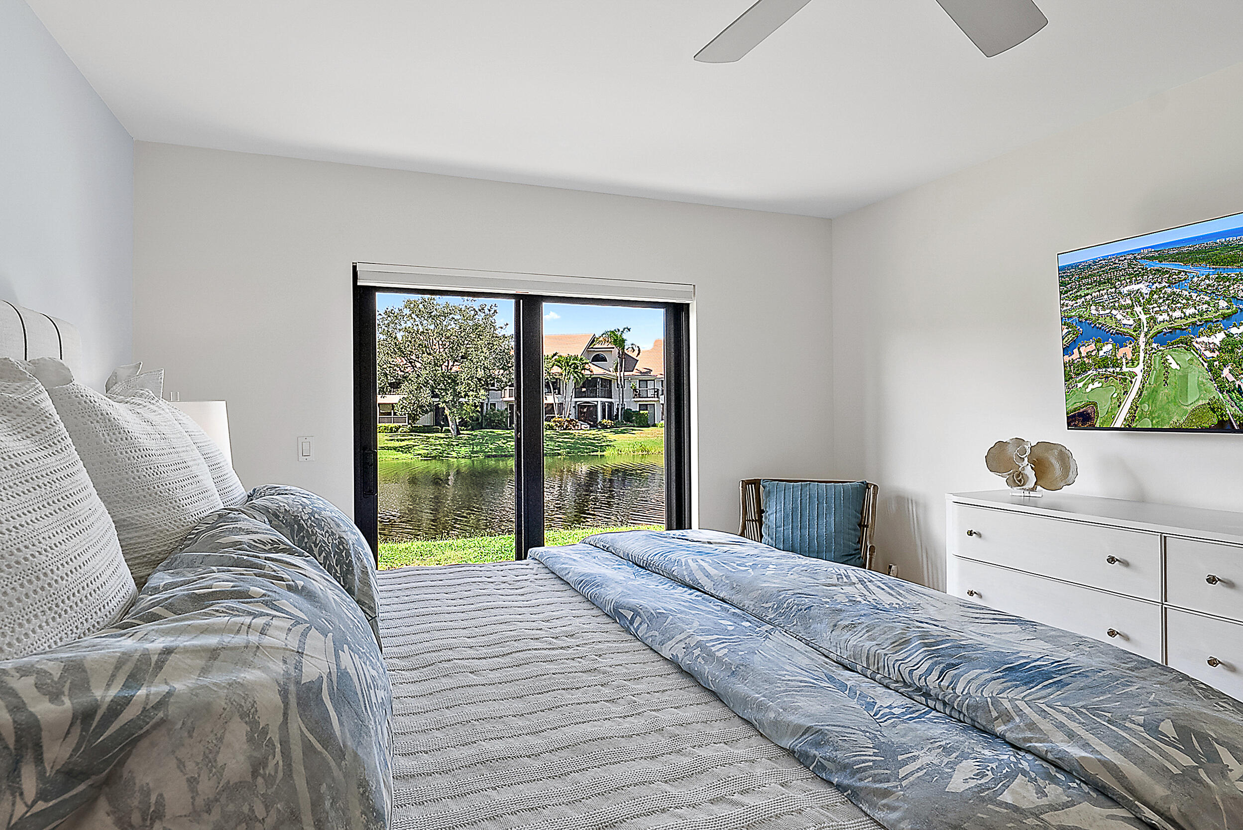 16647 Traders Crossing North, Unit 126 Jupiter, FL 33477 - Photo 19 of 45 a bedroom with a large bed and a window